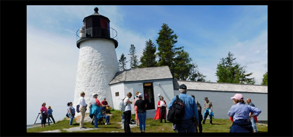 A Red Cloak Tour group explores Burnt Island Lighthouse and the surrounding buildings on a special excursion. (staff photo)
